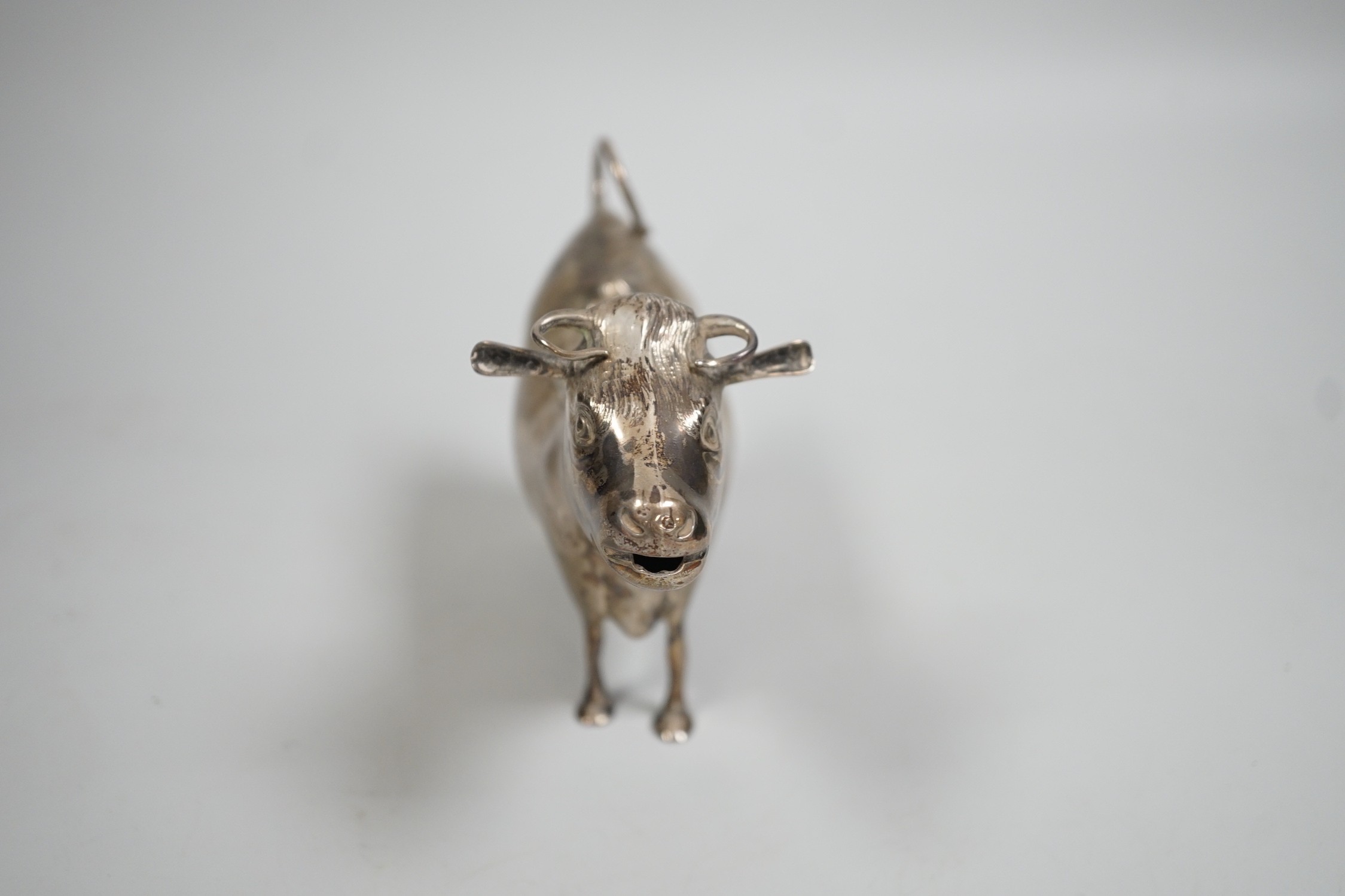 An Elizabeth II silver cow creamer, William Comyns & Sons Ltd, London, 1965, length 15cm, 152 grams.